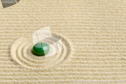 Image of Artistic composition with green drop on surface of yellow sand