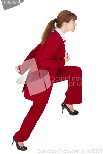 Image of Young woman in business suit is moving forward