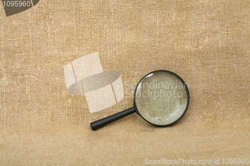 Image of Old black magnifier on drapery background