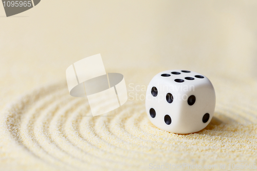 Image of Art composition from playing dice on sand