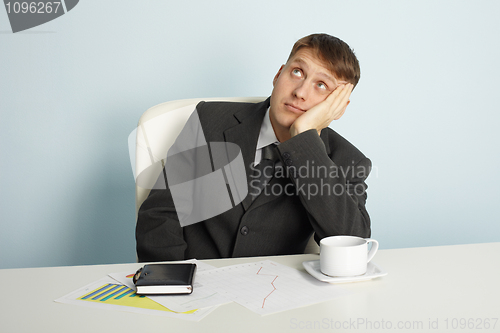 Image of Businessman pensively looks upwards
