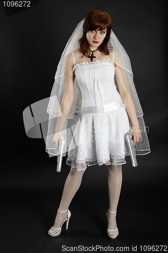 Image of Bride in white dress armed with two pistols