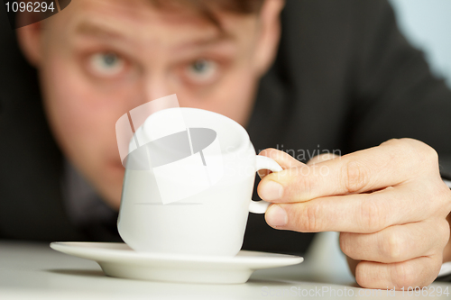 Image of Businessman makes predictions using coffee grounds