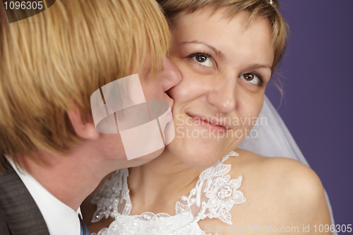 Image of Groom kisses bride