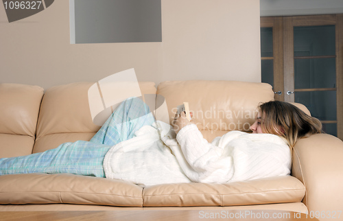 Image of young woman reading on sofa
