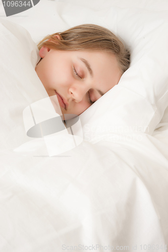Image of young woman asleep in bed