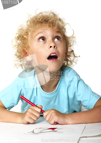 Image of little kid drawing and thinking