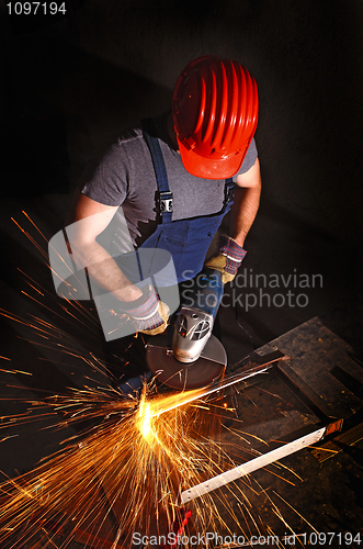 Image of worker with grinder