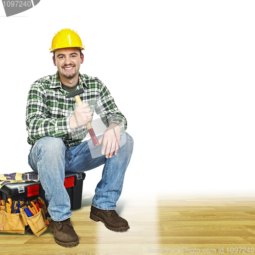 Image of handyman on wood floor