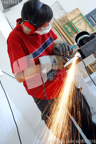 Image of metal worker with grinder