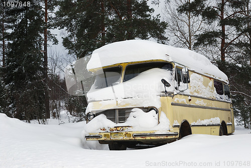 Image of old vinage bus covered with winter snow