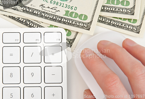 Image of Money, keyboard and hand on computer mouse