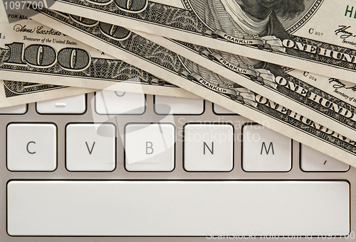 Image of Money bills on computer keyboard with spacebar