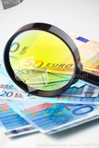 Image of Euro currency under a magnifying glass