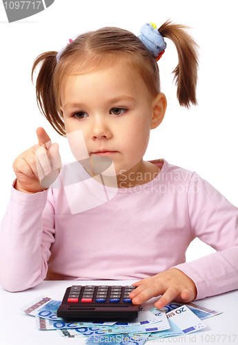 Image of Little girl plays with money