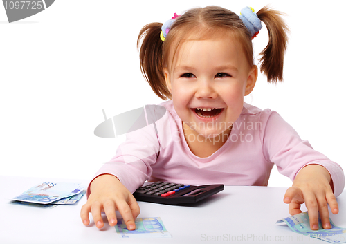 Image of Little girl with few paper euro banknotes