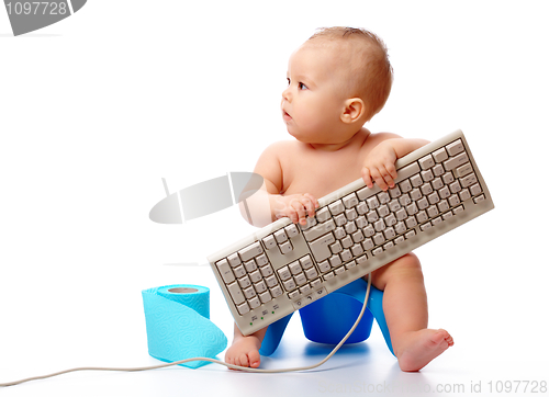 Image of Little child is typing on keyboard