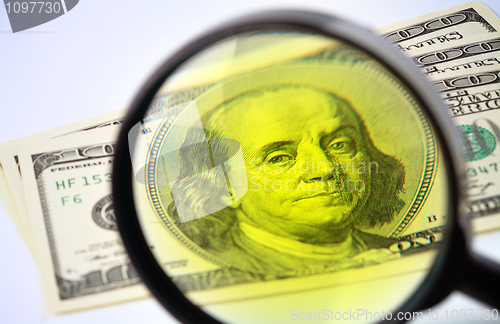 Image of Dollars under a magnifying glass