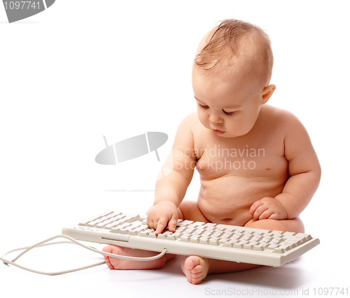 Image of Little child is typing on keyboard