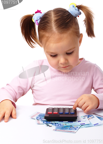 Image of Little girl plays with money