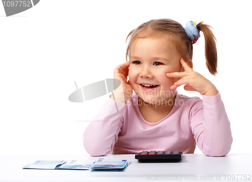 Image of Little girl with few paper euro banknotes