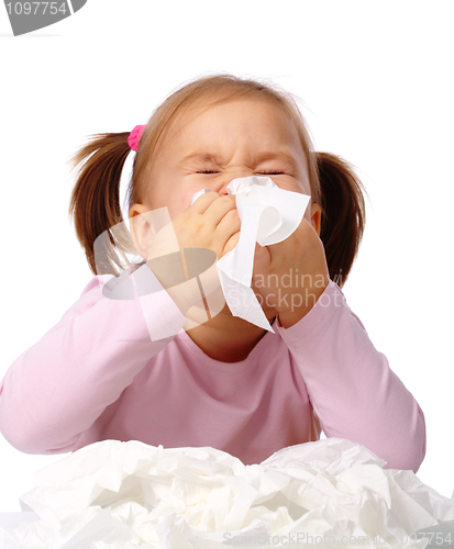 Image of Little girl blows her nose