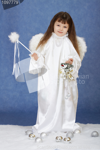 Image of Little girl in suit of angel on a blue background
