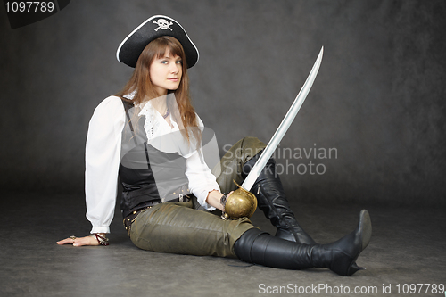 Image of Young beautiful woman in clothes of pirate with sabre