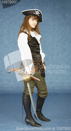 Image of Young woman in clothes of pirate on blue background