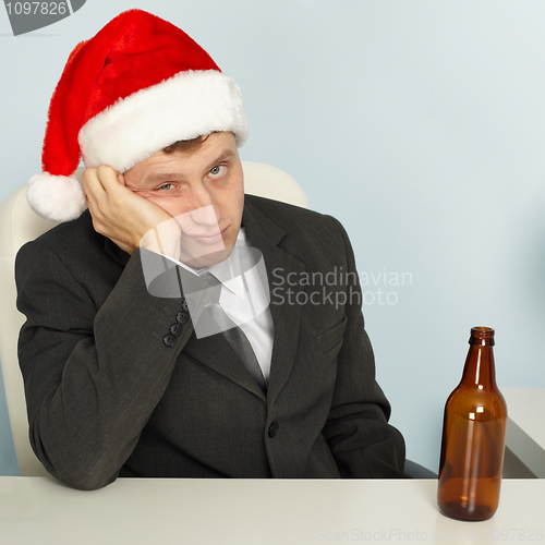 Image of Sad man suffering from hangover after Christmas