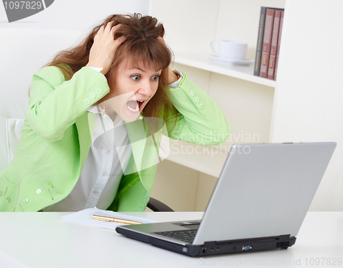 Image of Enraged woman reads news in Internet