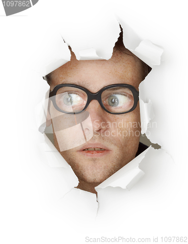 Image of Funny man in an old-fashioned glasses looking out of hole