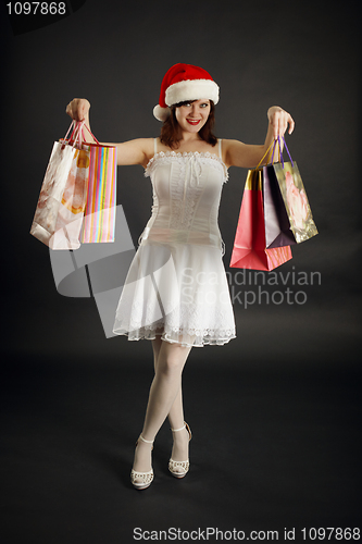 Image of Woman rejoices to Christmas purchases
