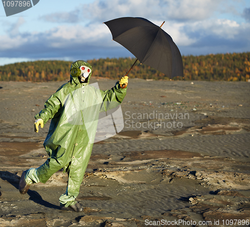 Image of Person in protective scientific overalls with umbrella