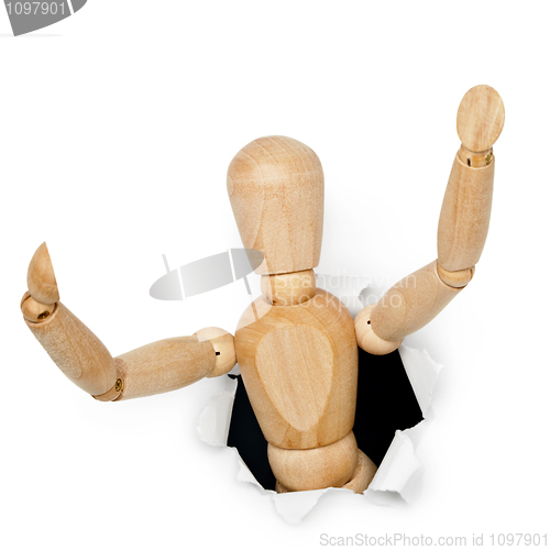Image of Wooden toy man looks out of hole