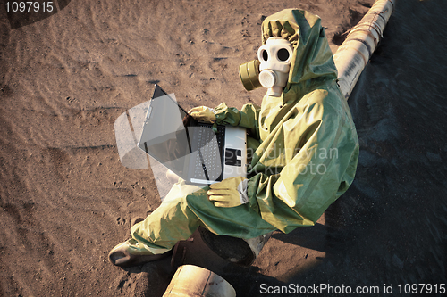 Image of Scientist with laptop in zone of ecological disaster