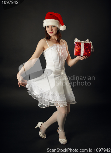 Image of Woman in Christmas cap with a celebratory gift