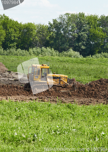 Image of Old caterpillar tractor works in fields