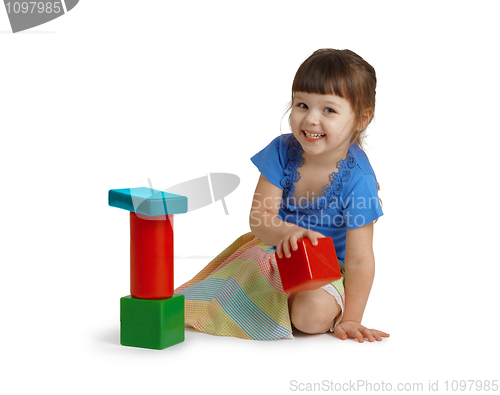 Image of Little girl playing with color toys isolated on white background