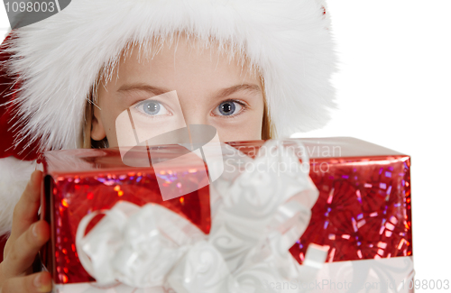Image of Teen girl in Christmas hat with a gift