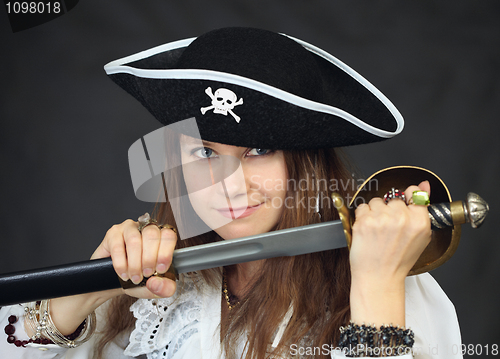 Image of Portrait of woman - pirate getting sabre from a sheath