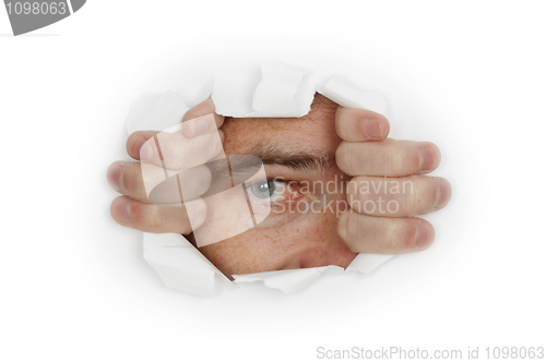Image of Man looks out a hole in white wall