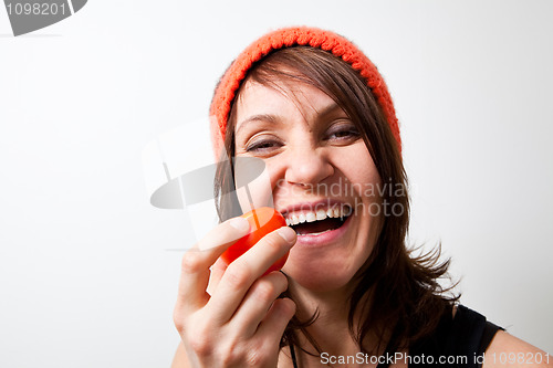 Image of Young woman tomato in hand