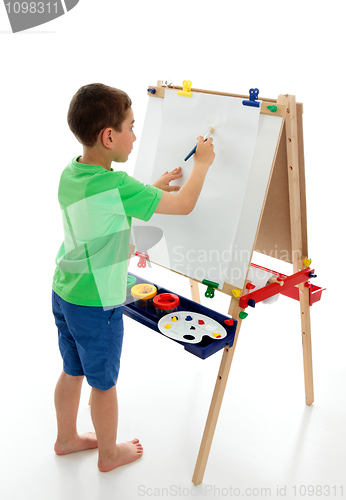 Image of Little boy starting to paint a picture 