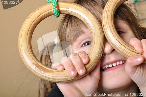 Image of child playing at gymnastic rings