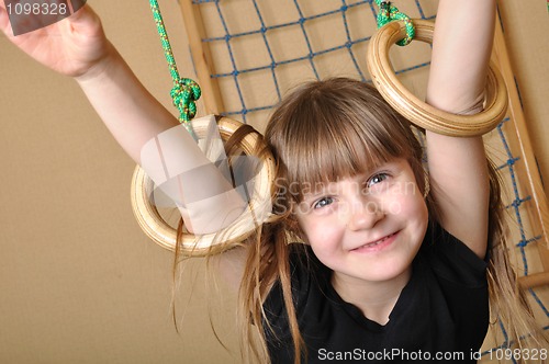 Image of child playing at gymnastic rings