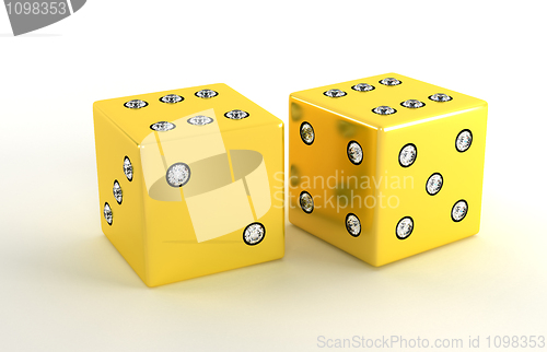 Image of Two golden polished dies with diamonds 