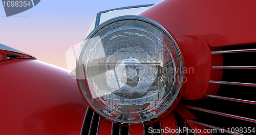 Image of Headlight and hood of red retro car