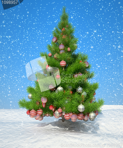 Image of Firtree with Xmas decoration during snowfall