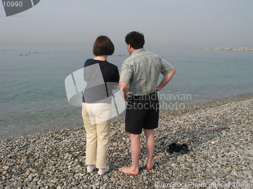 Image of Couple at the beach of Nice, France an early, misty morning.